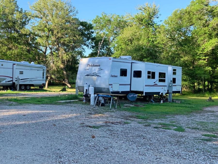 Travel trailer parked on a gravel RV site